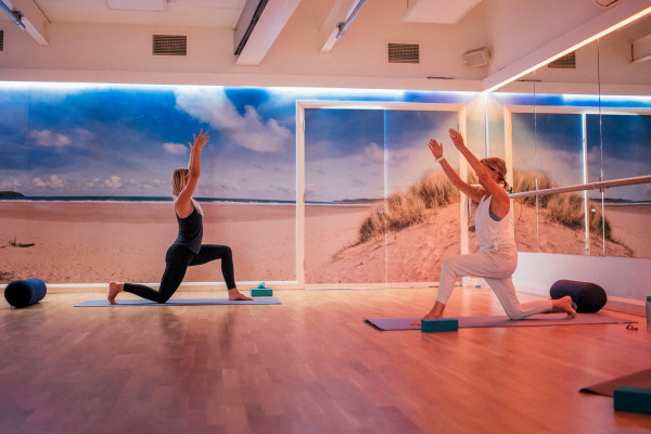 Female gym instructor guiding a yoga class at St Michaels Health Club