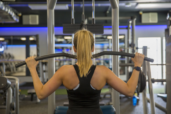 Female gym member using a resistance machine at the St Michaels Health Club
