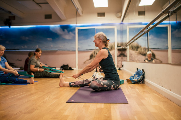 Yoga Class using resistance bands to aid stretching