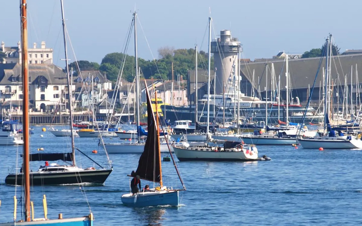 Boats in Falmouth harbour with the National Maritime Museum Cornwall tower behind